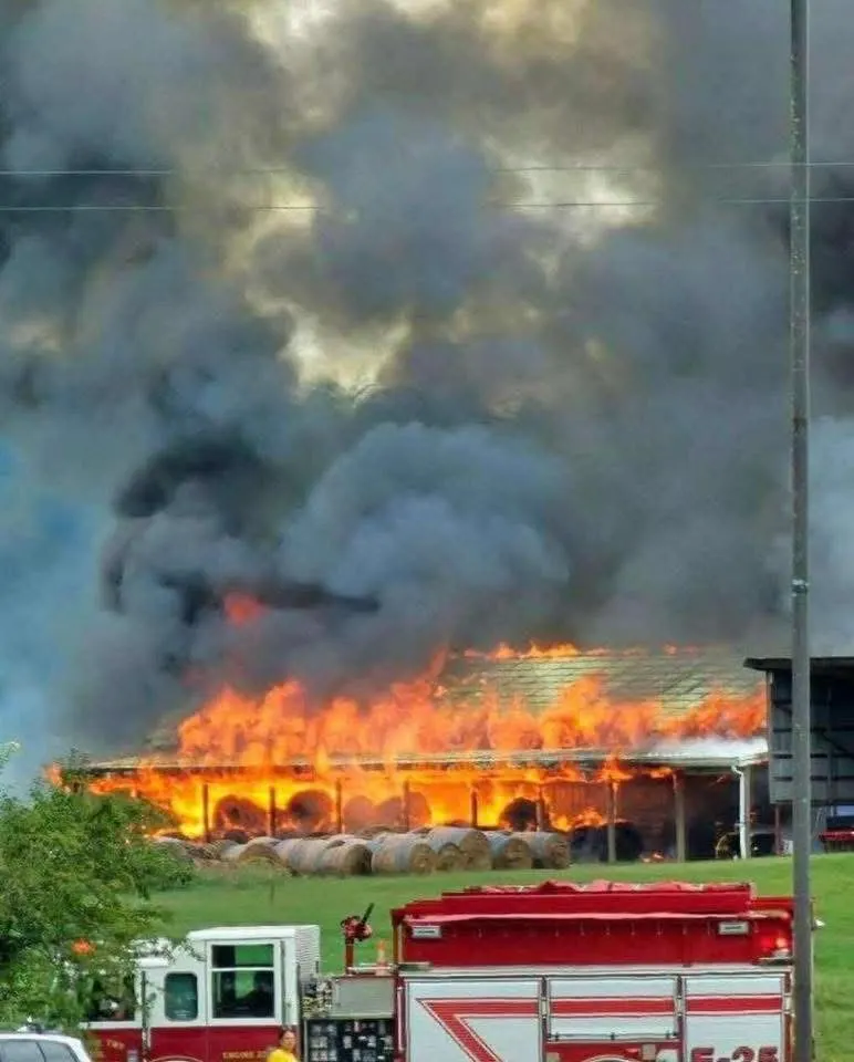Heavy smoke rising from a large fire at an industrial-looking structure.