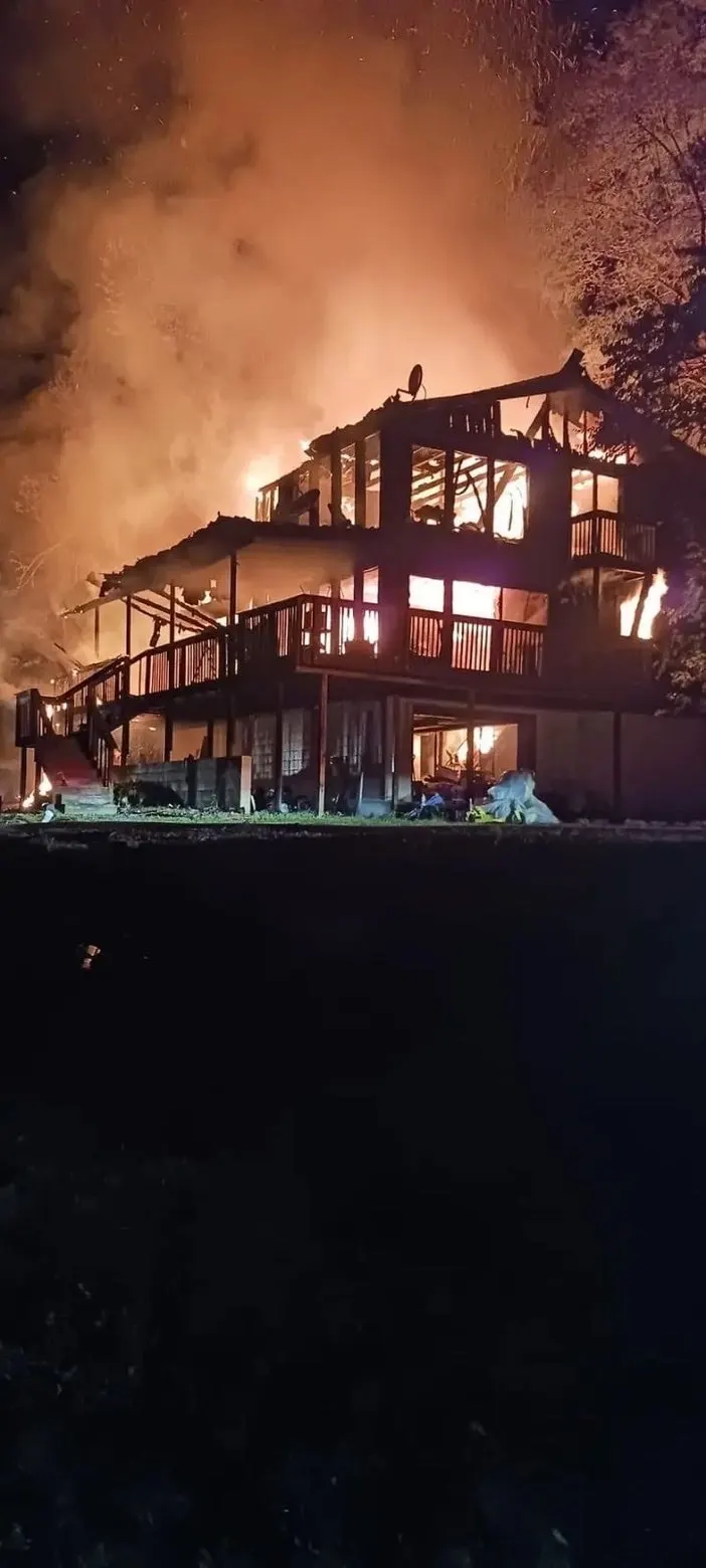 A large building burning at night.
