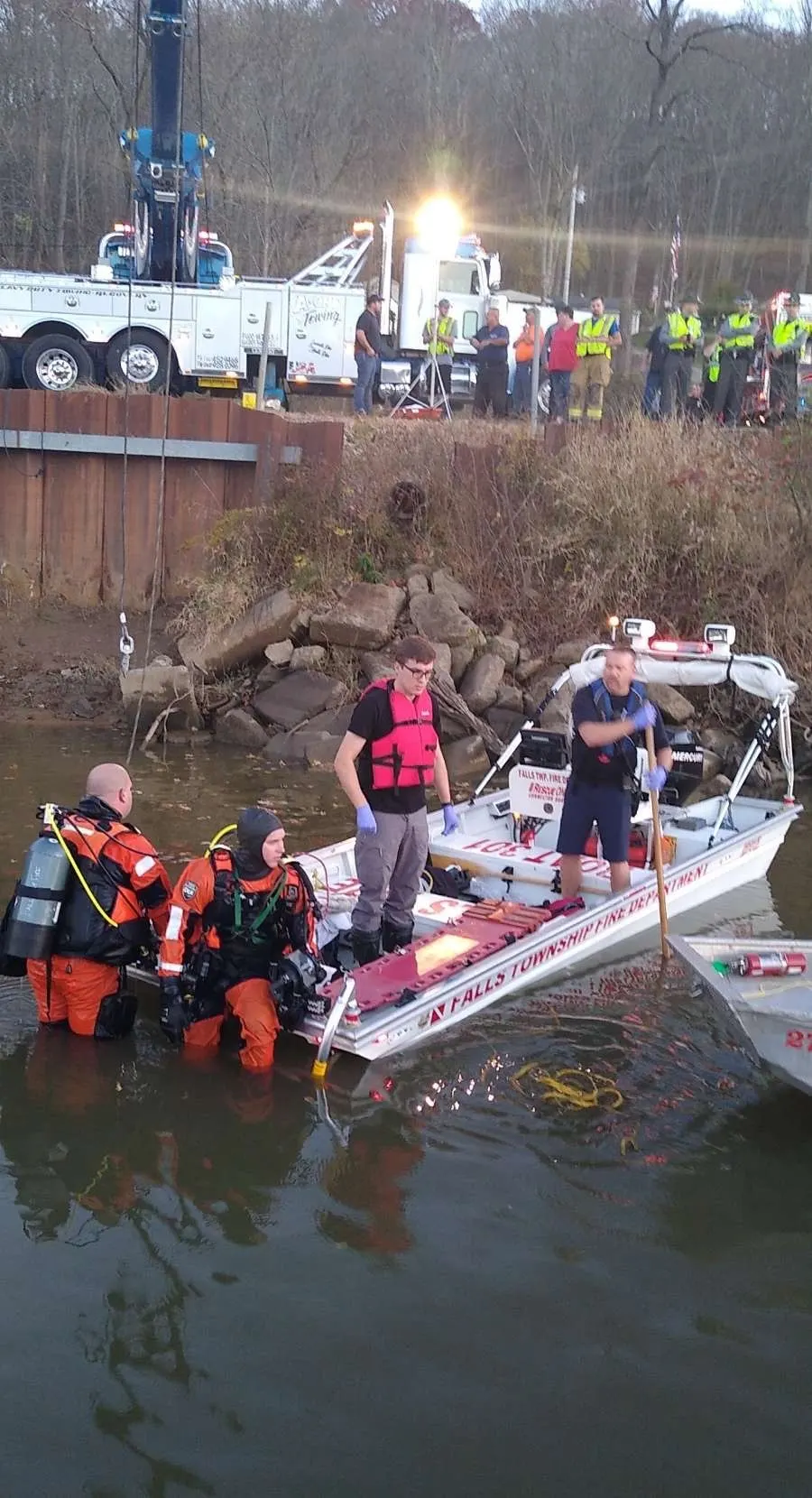 Water rescue responders working from a rescue boat near shore.